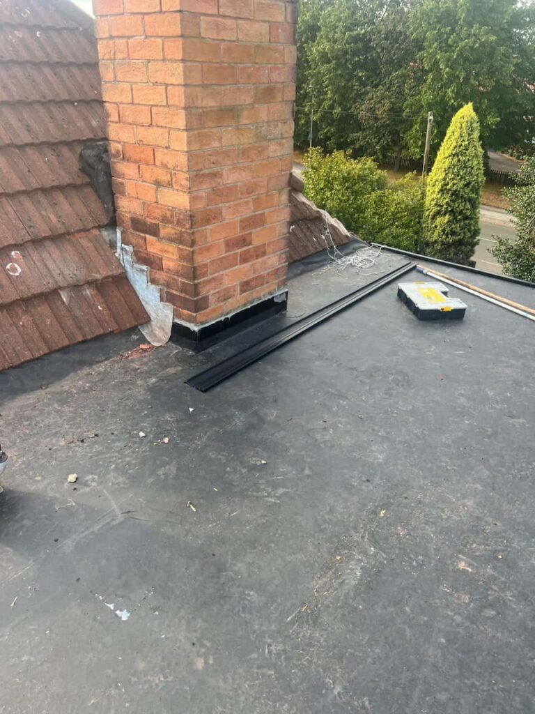 This is a photo of a flat roof which has just been repaired, there is also a chimney stack and some leadwork has also been dressed. Works carried out by TRP Roofing Brough
